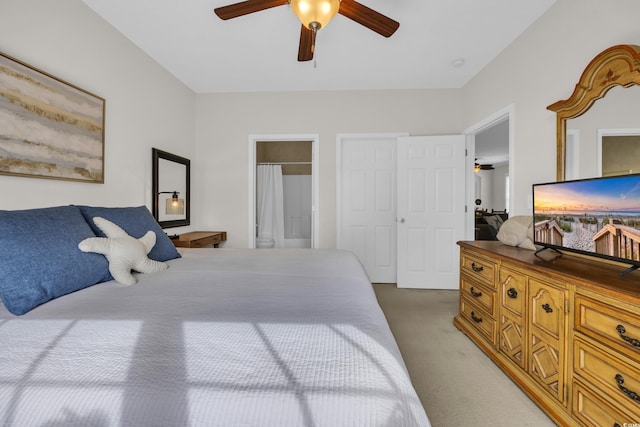 bedroom with ceiling fan, carpet flooring, and connected bathroom