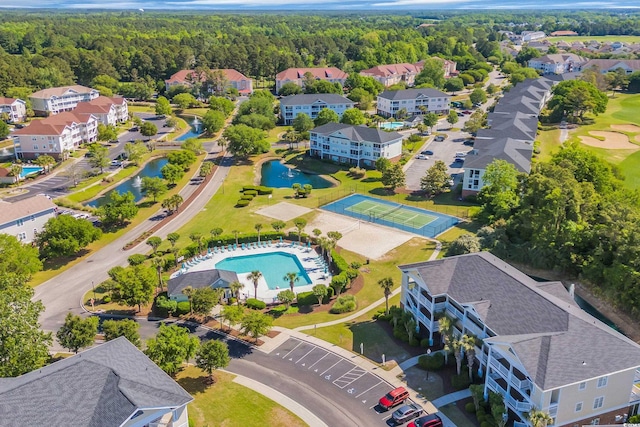 aerial view featuring a view of trees and a water view