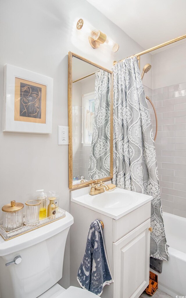 bathroom featuring toilet, shower / bath combo, and a sink