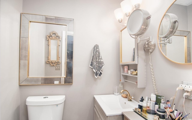 bathroom with toilet and vanity