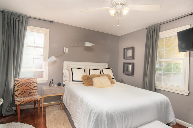 bedroom with wood finished floors, ceiling fan, and baseboards