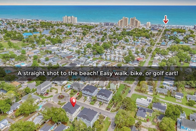 drone / aerial view featuring a water view and a residential view
