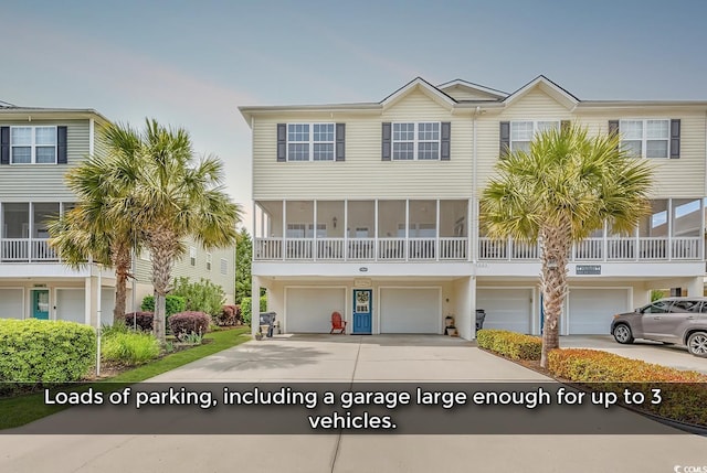 townhome / multi-family property with an attached garage and concrete driveway