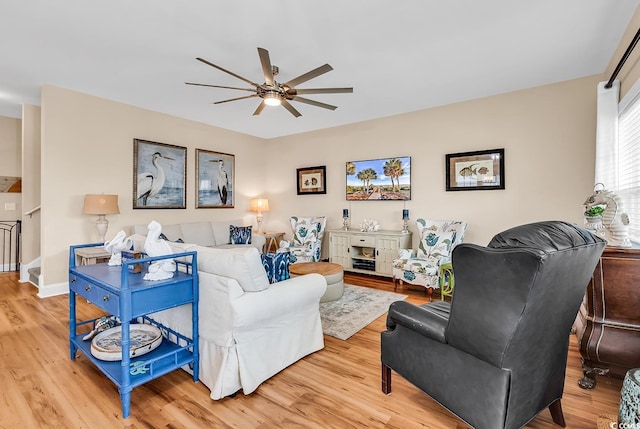 living area featuring ceiling fan and light wood-type flooring