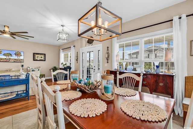 dining room with an inviting chandelier and light tile patterned floors