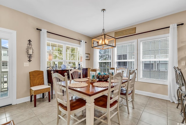 dining room with baseboards, light tile patterned flooring, and a chandelier