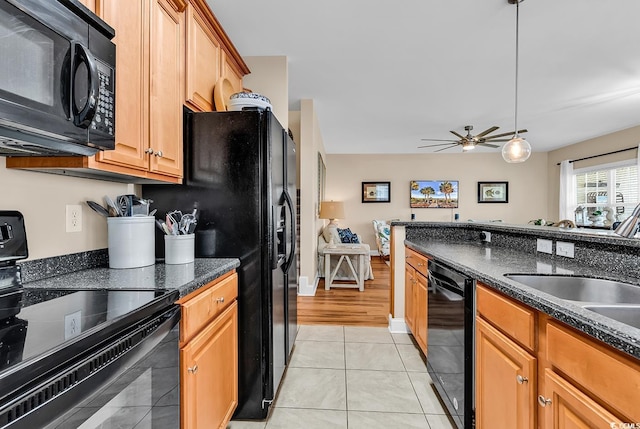 kitchen featuring ceiling fan, a sink, decorative light fixtures, light tile patterned floors, and black appliances