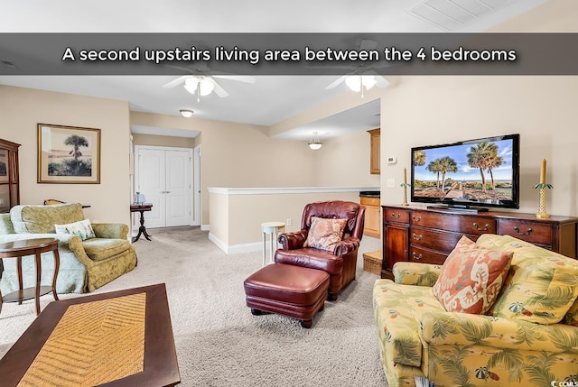 living area featuring baseboards, ceiling fan, and light colored carpet