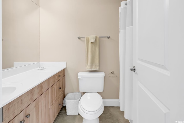 full bath with vanity, baseboards, tile patterned floors, and toilet