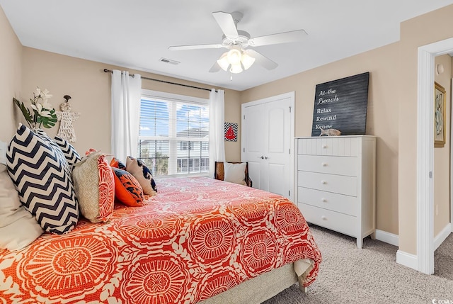bedroom with visible vents, carpet floors, a closet, baseboards, and ceiling fan