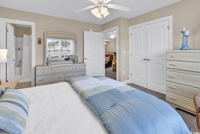 bedroom featuring carpet flooring, connected bathroom, a ceiling fan, baseboards, and a closet