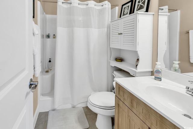 bathroom with vanity, tile patterned flooring, toilet, and shower / tub combo