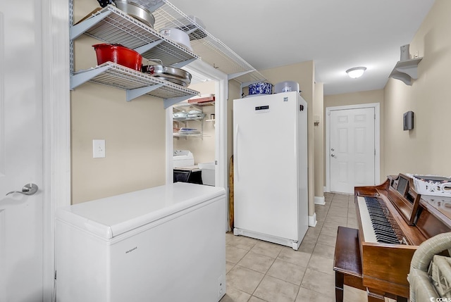 laundry area with light tile patterned floors and laundry area