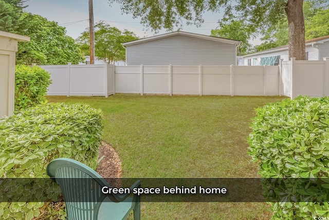 view of yard with a fenced backyard