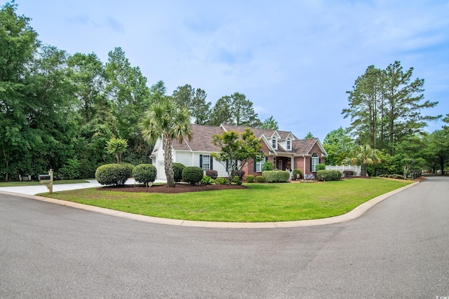new england style home featuring a front yard