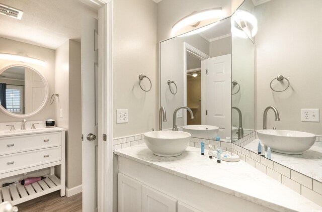 5523 N Ocean Blvd Unit 1201, Myrtle Beach, SC 29577 - bathroom featuring vanity, wood finished floors, and ornamental molding