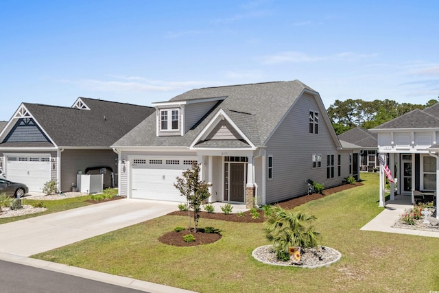 view of front facade with an attached garage, a front lawn, roof with shingles, and driveway