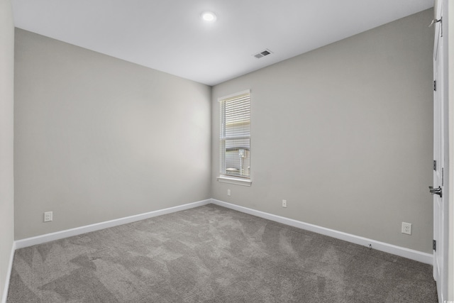 unfurnished room featuring carpet flooring, baseboards, and visible vents
