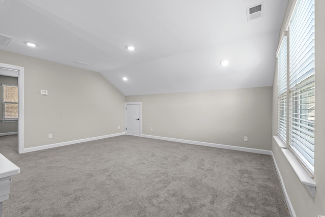 interior space featuring visible vents, carpet, recessed lighting, baseboards, and vaulted ceiling