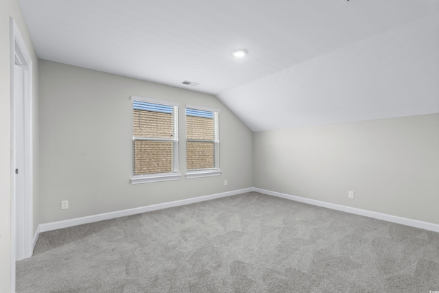 bonus room with visible vents, baseboards, and lofted ceiling