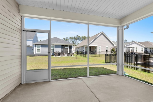 unfurnished sunroom with a residential view