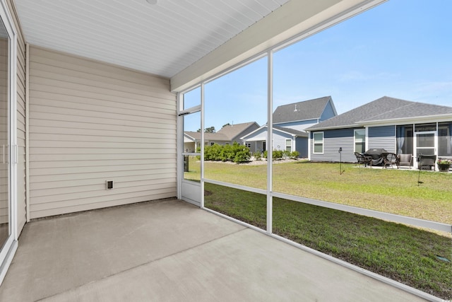 unfurnished sunroom with a residential view