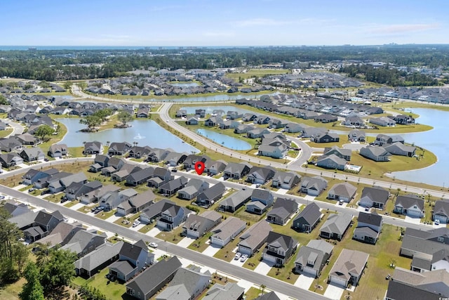 drone / aerial view with a residential view and a water view