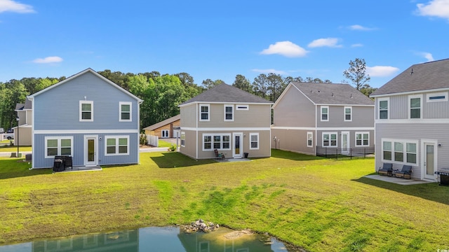 3968 Hibiscus Dr, Little River, SC 29566 - back of property with a patio area and a lawn