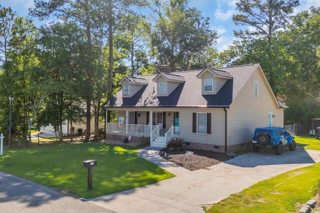 new england style home featuring covered porch, a front yard, a chimney, crawl space, and driveway