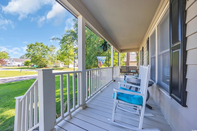 deck featuring a yard and a porch