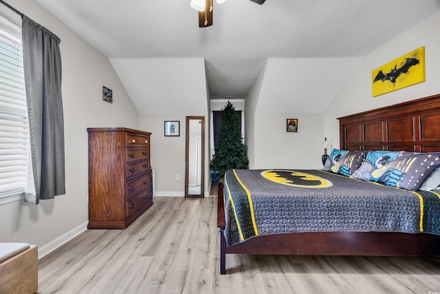 bedroom featuring a ceiling fan, baseboards, vaulted ceiling, and light wood finished floors
