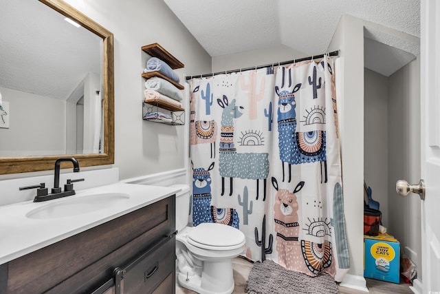 full bathroom with vanity, a shower with curtain, toilet, and a textured ceiling