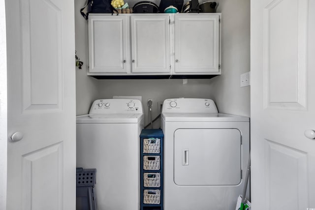 laundry area featuring cabinet space and separate washer and dryer