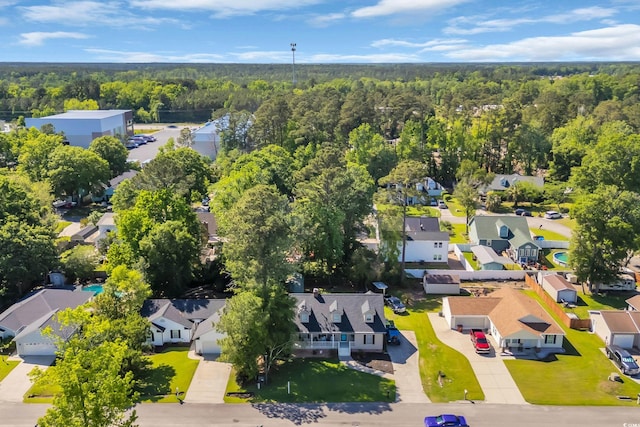 birds eye view of property featuring a view of trees and a residential view