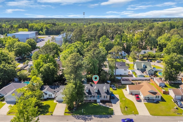drone / aerial view featuring a view of trees and a residential view