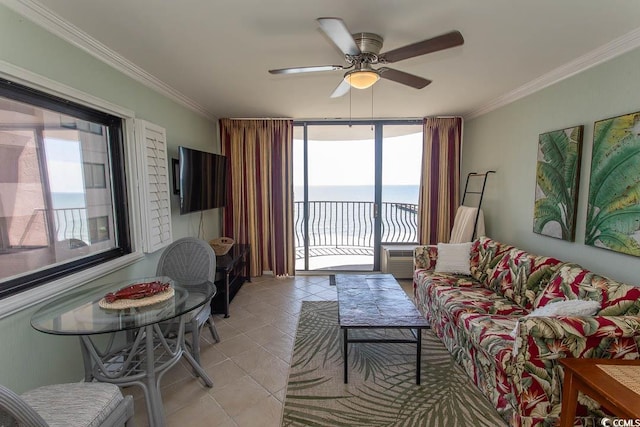 living area with crown molding, a ceiling fan, and light tile patterned flooring