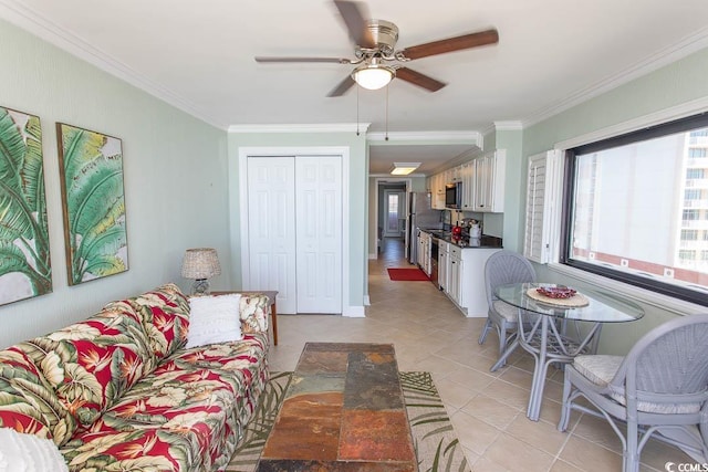 living area featuring crown molding, ceiling fan, and light tile patterned floors