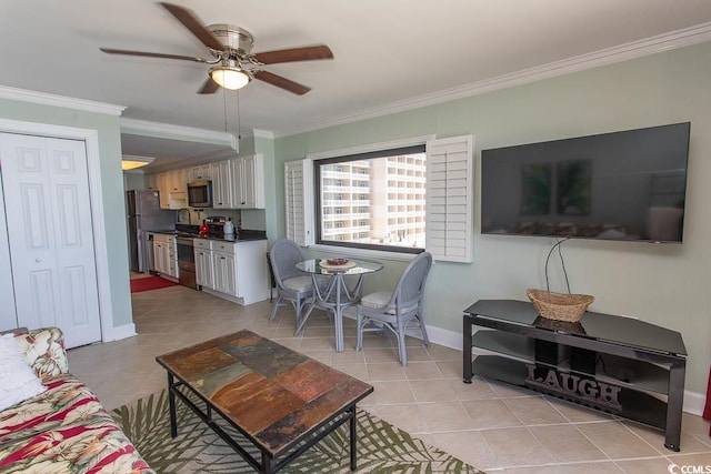 living room with crown molding, a ceiling fan, baseboards, and light tile patterned floors