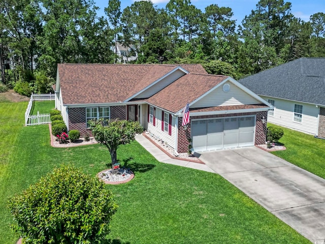 ranch-style home with a garage, concrete driveway, a front yard, and brick siding