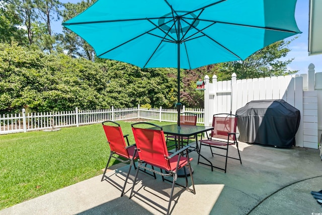 view of patio with outdoor dining area, a fenced backyard, and a grill