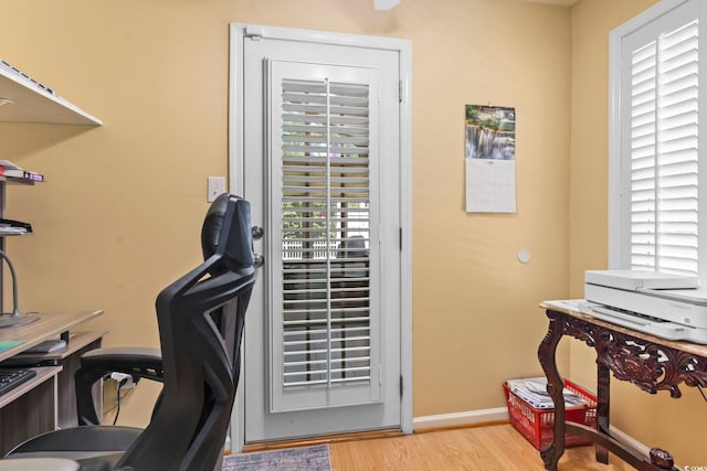 office area featuring baseboards and wood finished floors