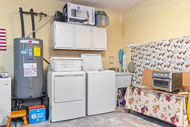 laundry room featuring washing machine and clothes dryer, cabinet space, a sink, a toaster, and electric water heater