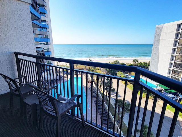 balcony featuring a beach view and a water view
