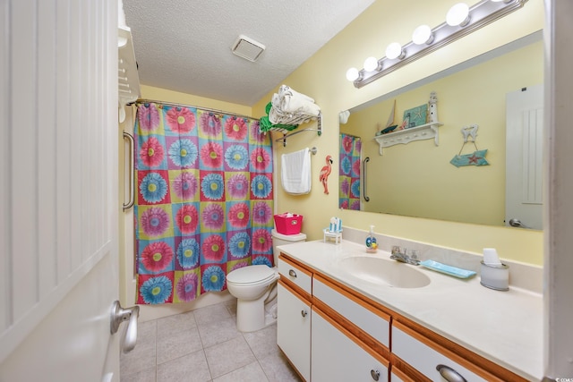 full bath with tile patterned floors, toilet, vanity, and a textured ceiling