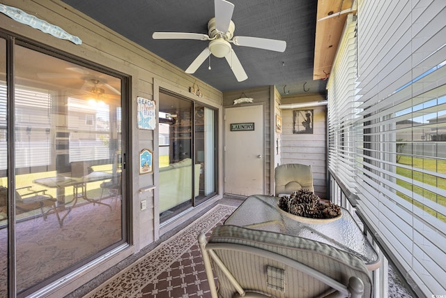 sunroom / solarium with a ceiling fan