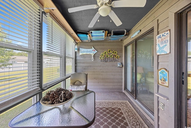 sunroom / solarium featuring ceiling fan