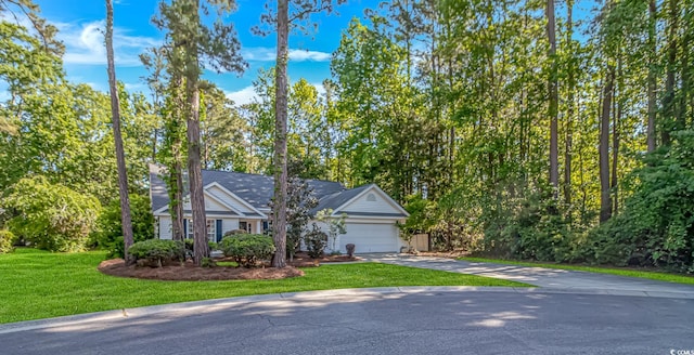 exterior space featuring a garage, driveway, and a front yard