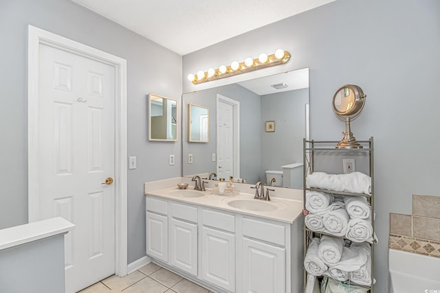 full bathroom with double vanity, a washtub, a sink, and tile patterned flooring
