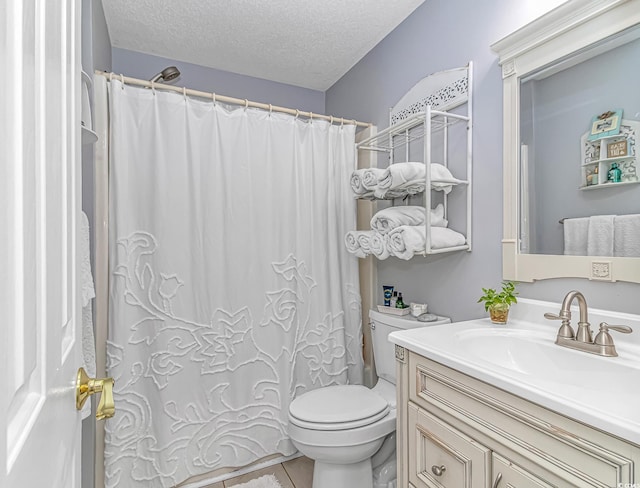 bathroom featuring vanity, tile patterned flooring, curtained shower, toilet, and a textured ceiling