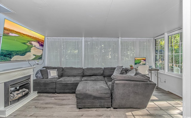 living area with plenty of natural light and wood finished floors